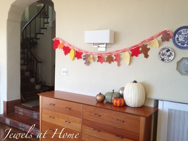A charming fall garland made of fabric leaves.  Over the years, each family member can record a Thanksgiving reflection on the back of a leaf to create a special tradition.  Jewels at Home.